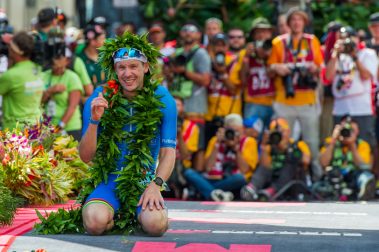 2018 Ironman World Champion Patrick Lange gives a shaka at the finish line.