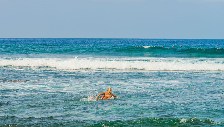 Surfer Paddling Out at Kohanaiki Beach