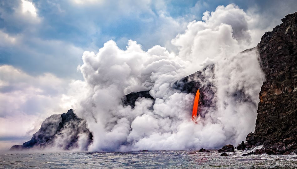 Lava Boat Tour showing a spout of lava pouring into the ocean